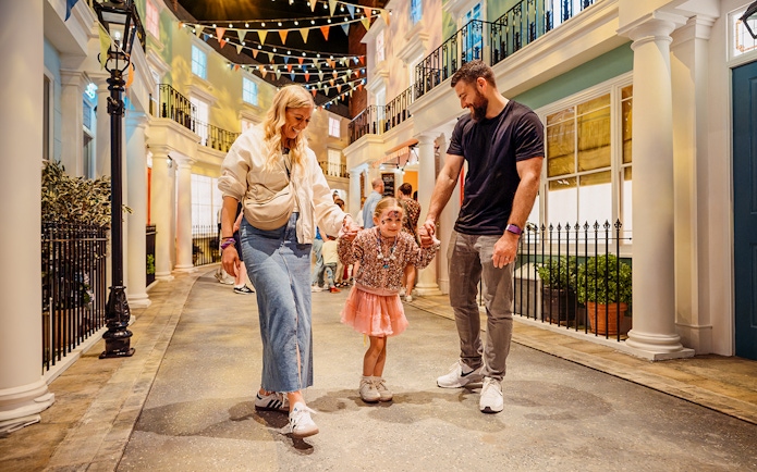 Children with parents enjoying The Paddington Bear Experience in London.