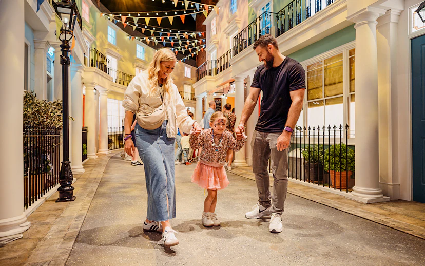Children with parents enjoying The Paddington Bear Experience in London.