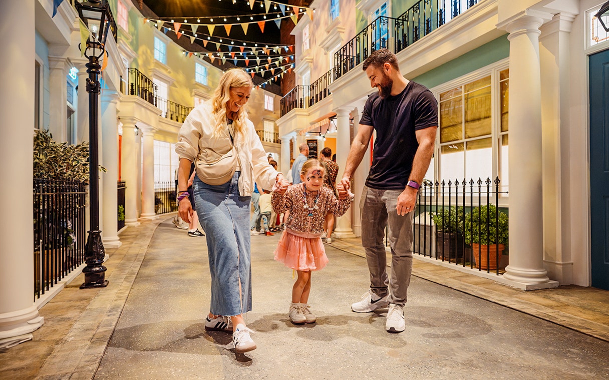 Children with parents enjoying The Paddington Bear Experience in London.