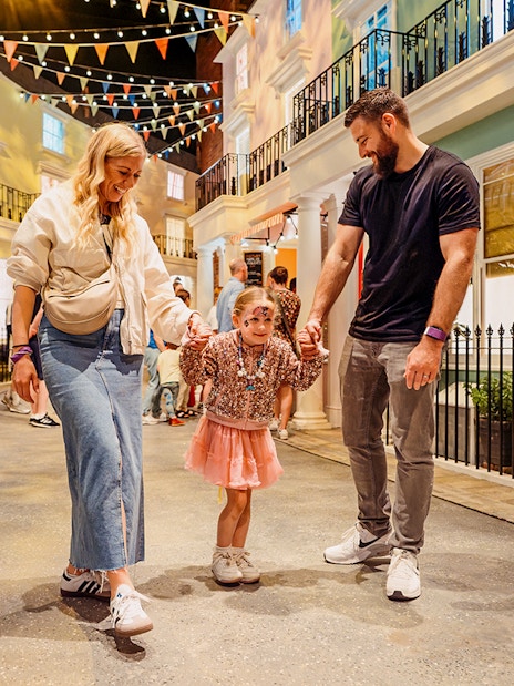 Children with parents enjoying The Paddington Bear Experience in London.