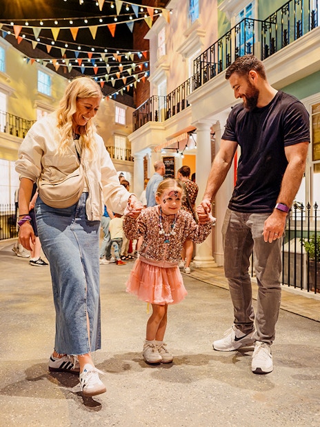 Children with parents enjoying The Paddington Bear Experience in London.