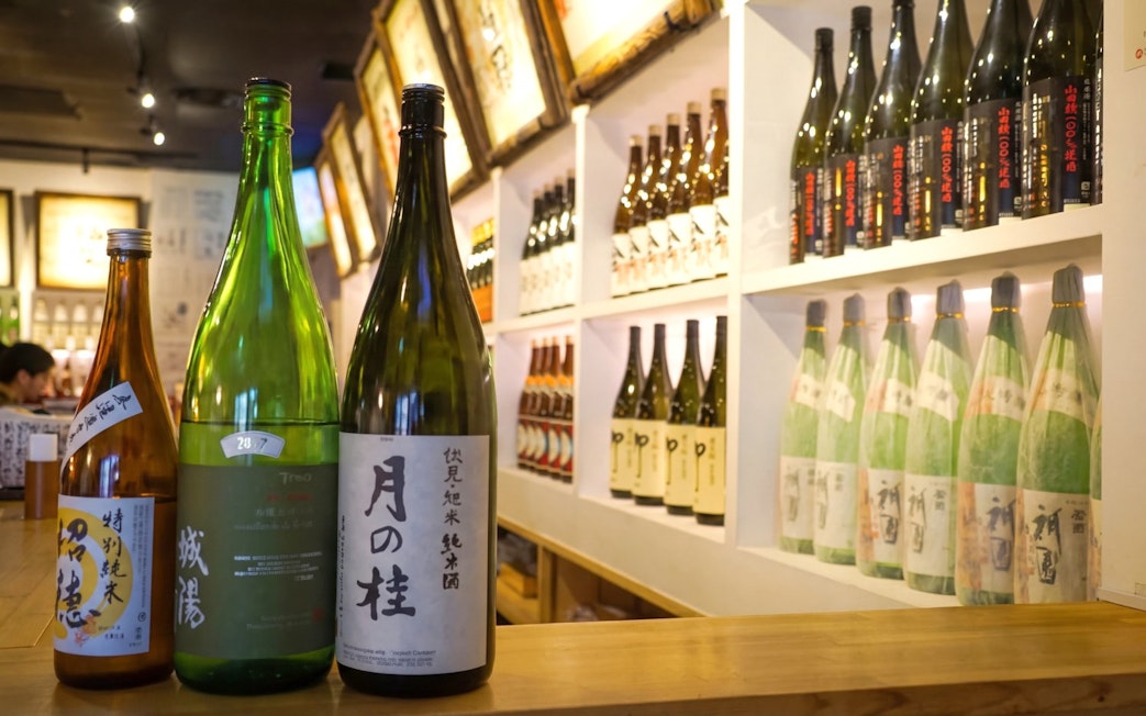 Sake bottles displayed at a Kyoto brewery during a tasting tour.