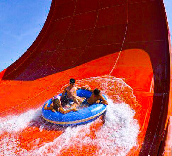 Visitors on a raft ride down a steep water slide at Splash Out Langkawi.
