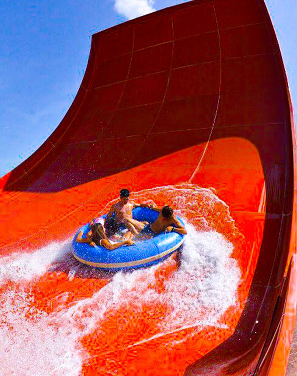 Visitors on a raft ride down a steep water slide at Splash Out Langkawi.