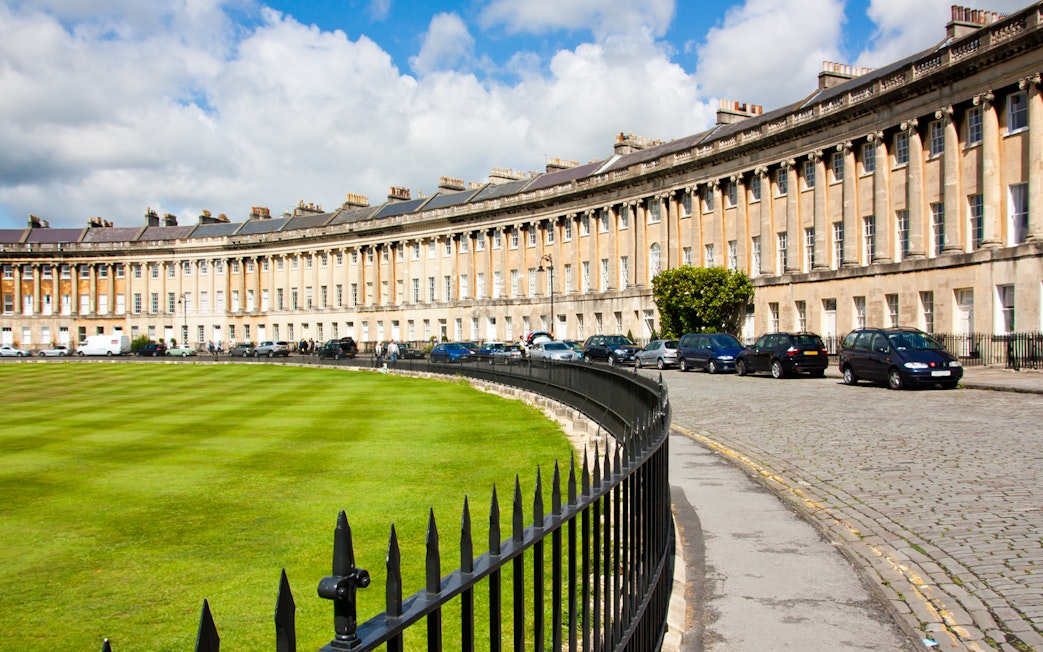 Royal Crescent in Bath, England, with historic Georgian architecture and a curved lawn.