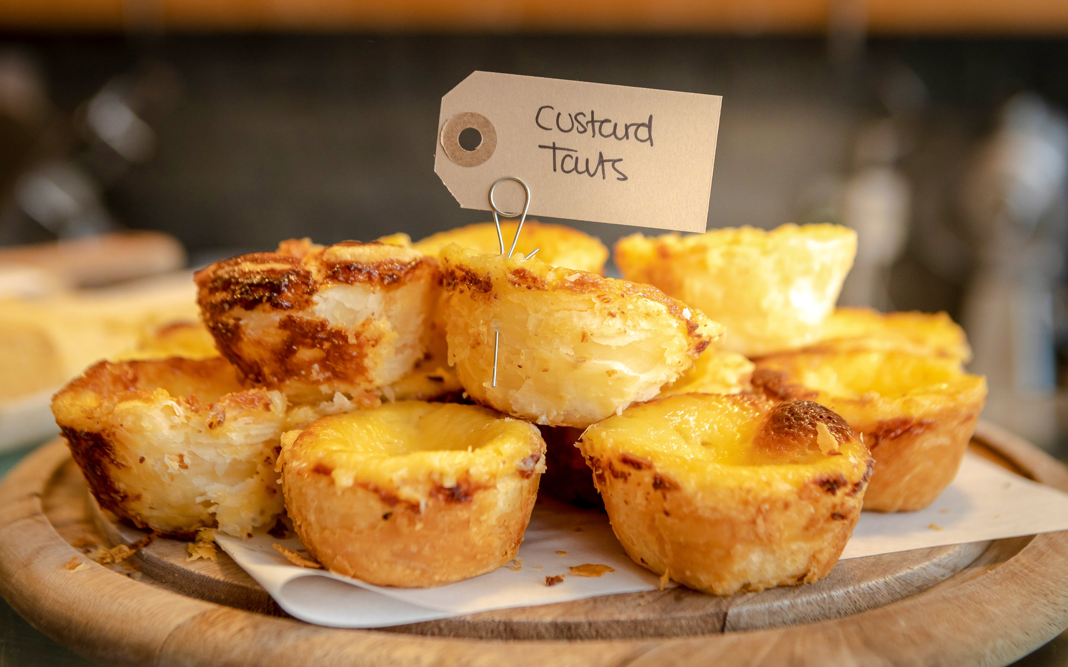 Pile of custard tarts on a plate during Glasgow food tour.
