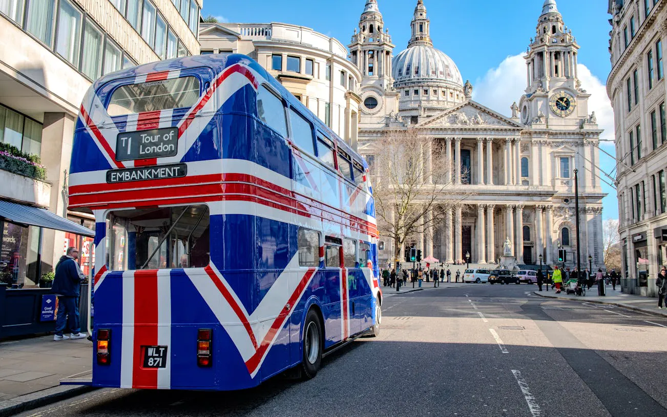Double-decker bus with Union Jack design near St. Paul's Cathedral, Central London.