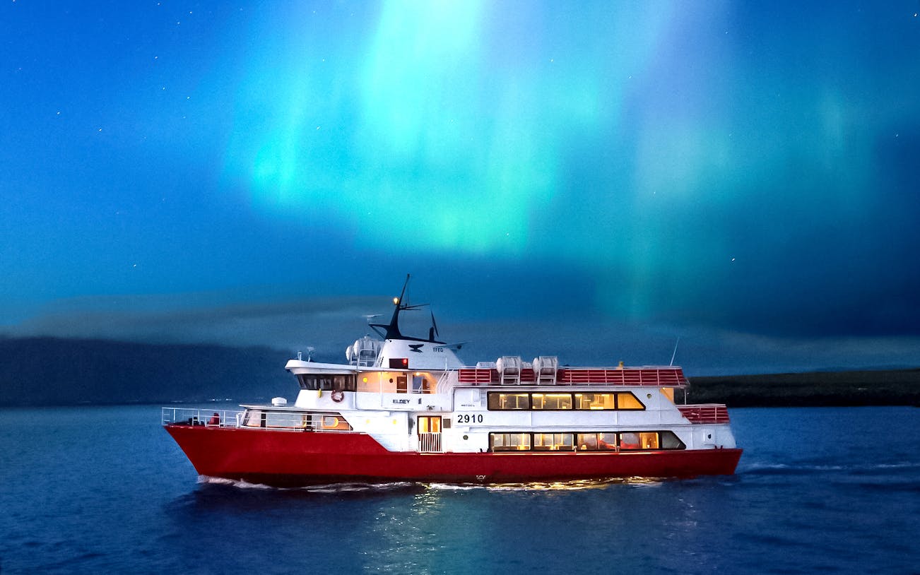 Cruise ship under Northern Lights near Reykjavik, Iceland.