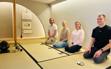 Tourists participating in a traditional tea ceremony in Kyoto, Japan.