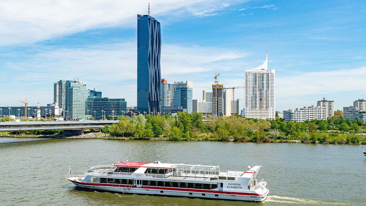Danube River cruise in Vienna with passengers enjoying brunch and live music on deck.