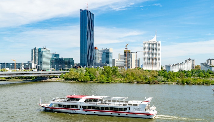 Danube River cruise in Vienna with passengers enjoying brunch and live music on deck.