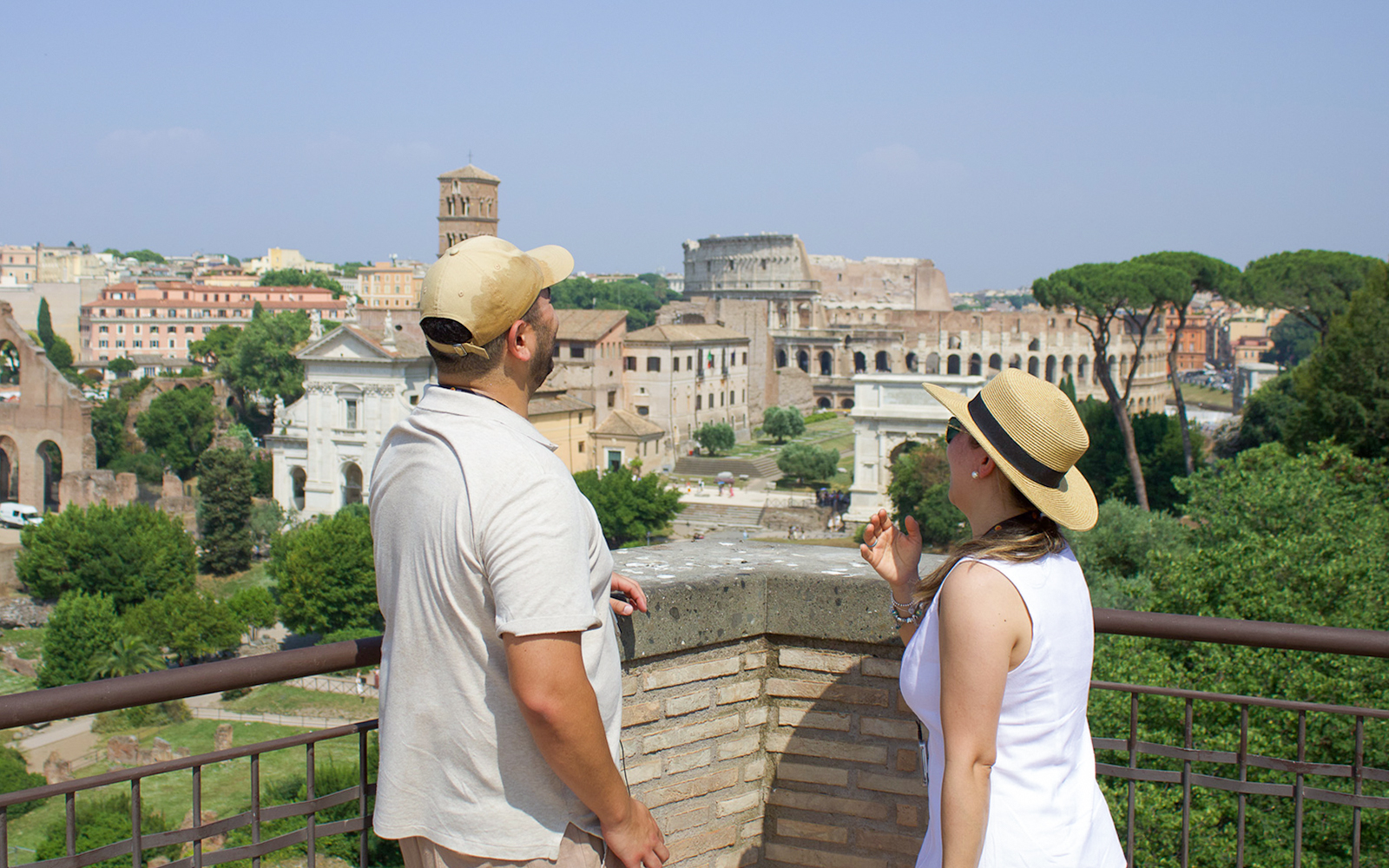 Couple admiring the Roman Forum view during a guided tour in Rome.