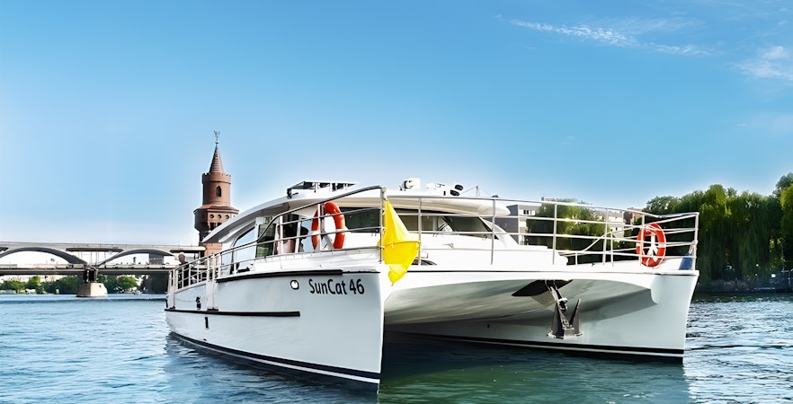Berlin catamaran on the river with Oberbaum Bridge in the background.