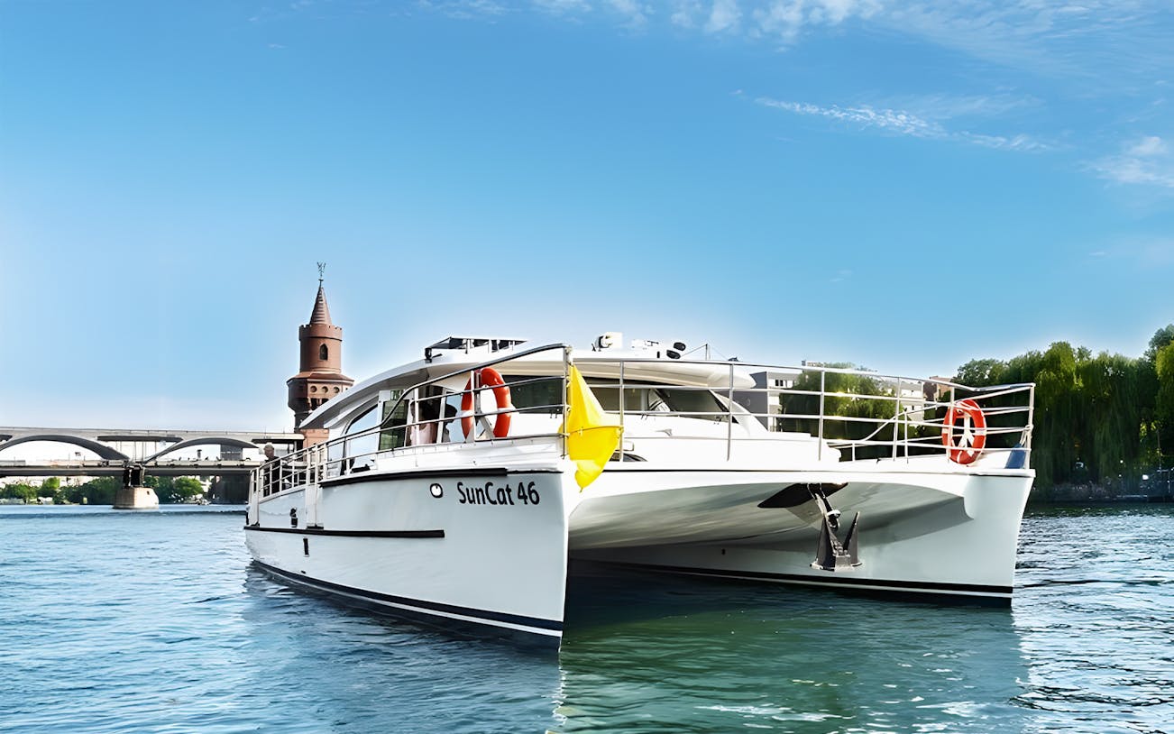Berlin catamaran on the river with Oberbaum Bridge in the background.