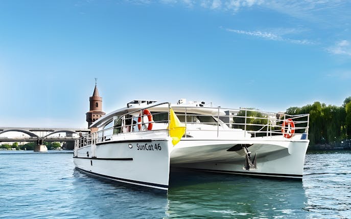 Berlin catamaran on the river with Oberbaum Bridge in the background.