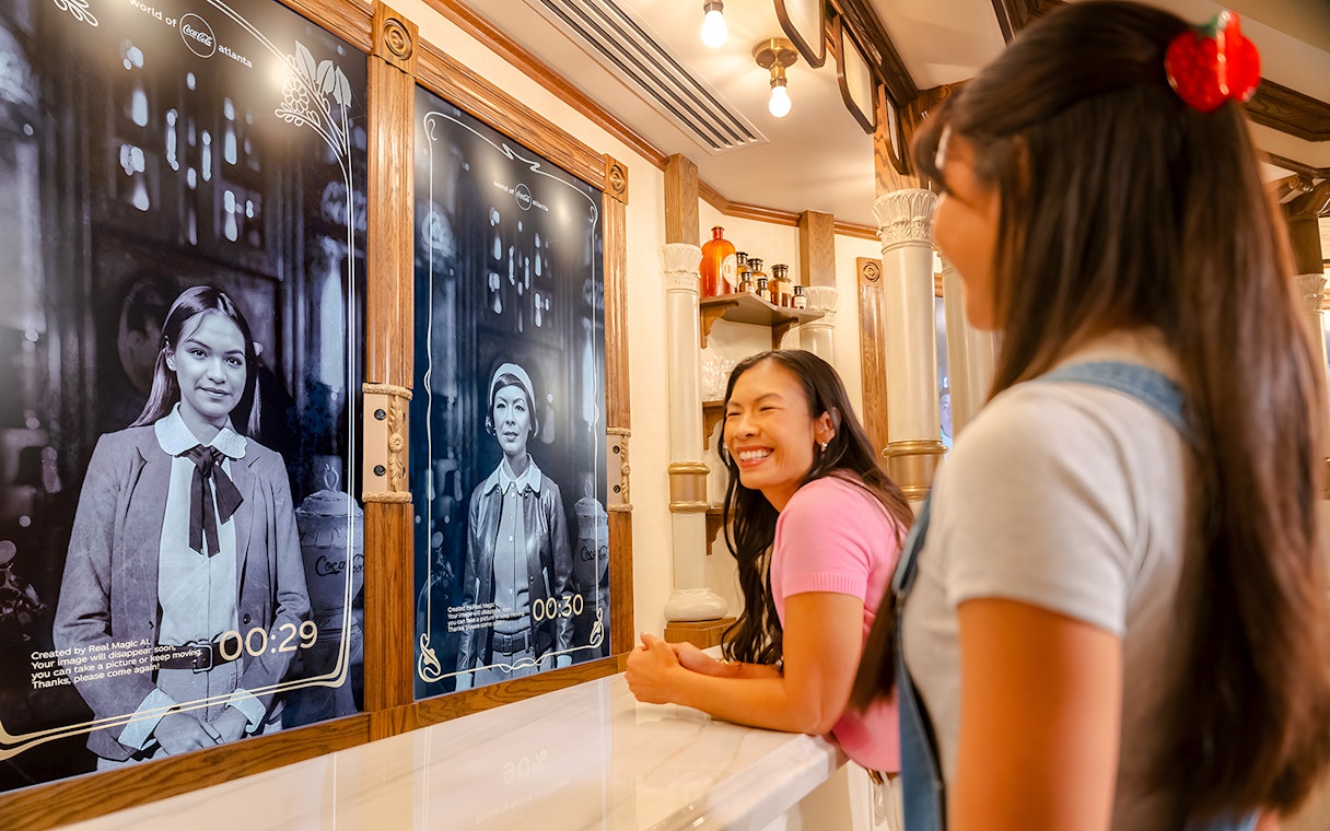 Friends enjoying interactive exhibit at World of Coca-Cola Museum, Atlanta.