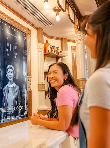 Friends enjoying interactive exhibit at World of Coca-Cola Museum, Atlanta.