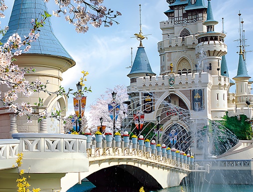 Lotte World castle with bridge and cherry blossoms in Seoul, South Korea.