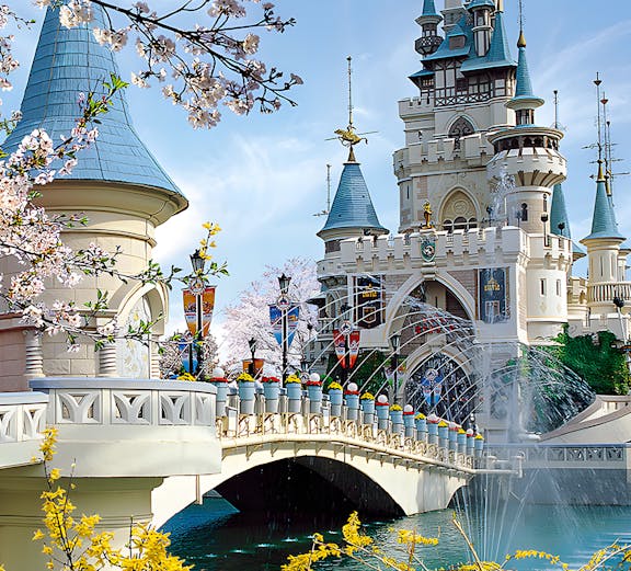 Lotte World castle with bridge and cherry blossoms in Seoul, South Korea.