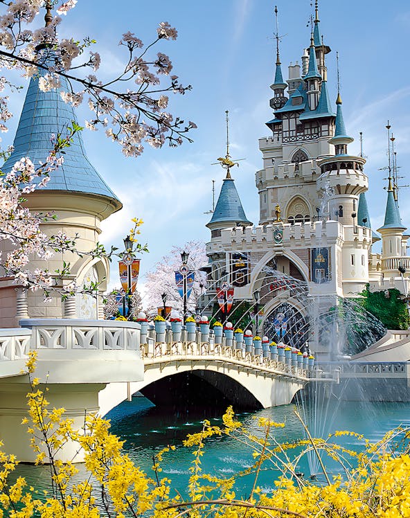 Lotte World castle with bridge and cherry blossoms in Seoul, South Korea.