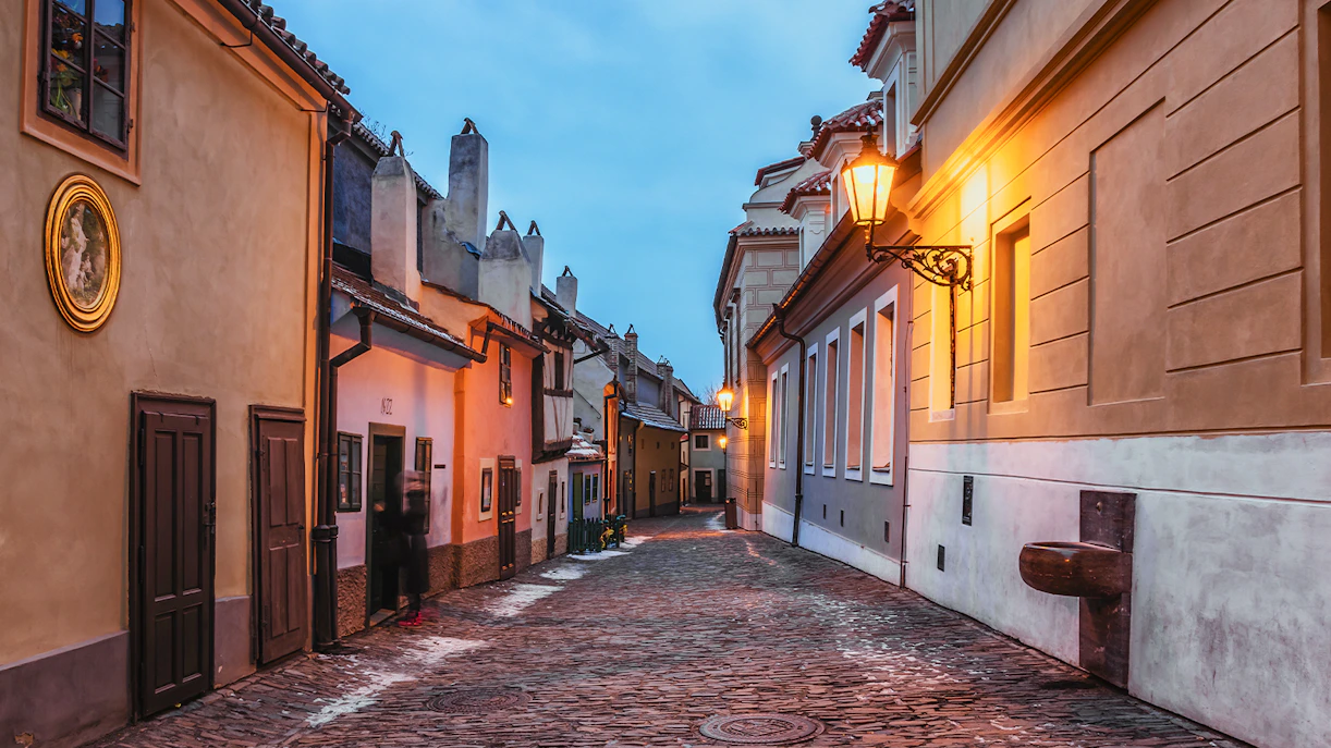 Golden Lane in Prague Castle with colorful historic houses and cobblestone street.