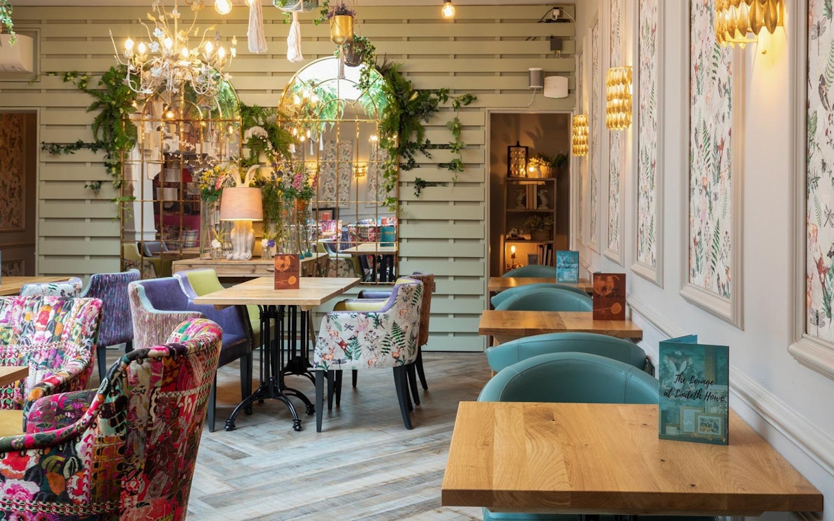 Elegant tea room with floral decor in the Lake District, part of a day tour from London.