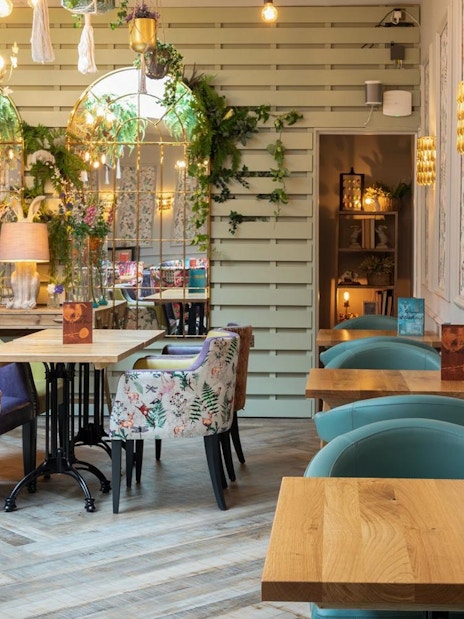 Elegant tea room with floral decor in the Lake District, part of a day tour from London.
