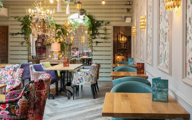 Elegant tea room with floral decor in the Lake District, part of a day tour from London.