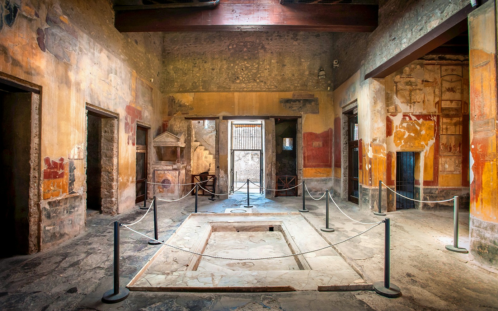 Entrance vestibule of the House of Menander in Pompeii, featuring ancient frescoes and architecture.