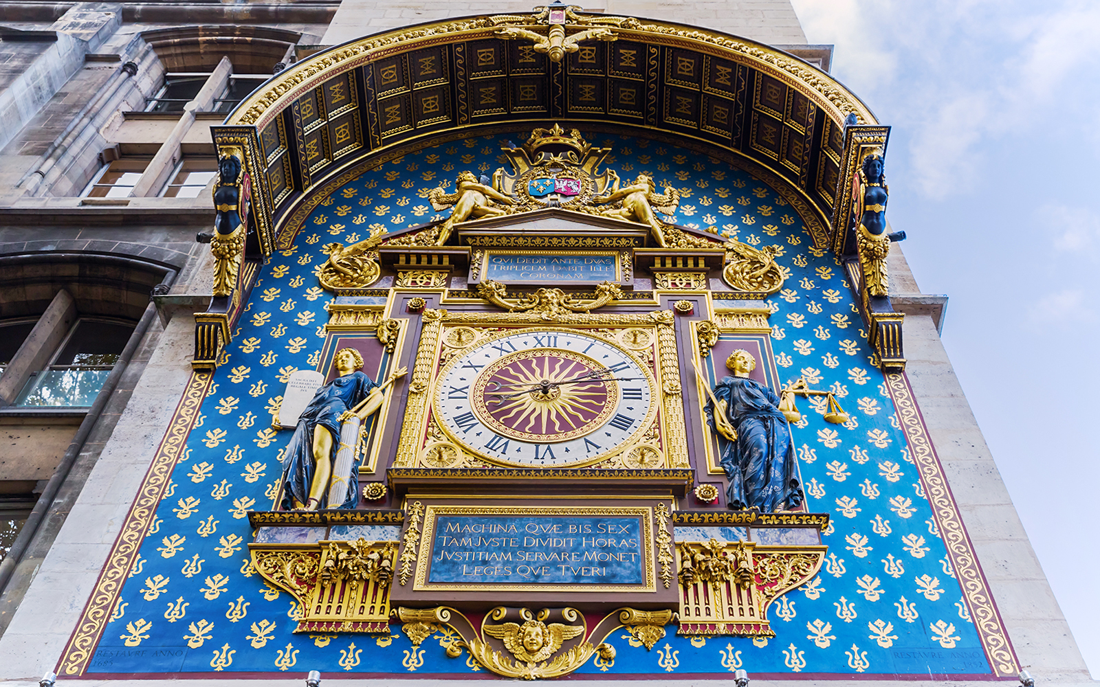 Astronomical clock on Conciergerie facade in Paris, France.