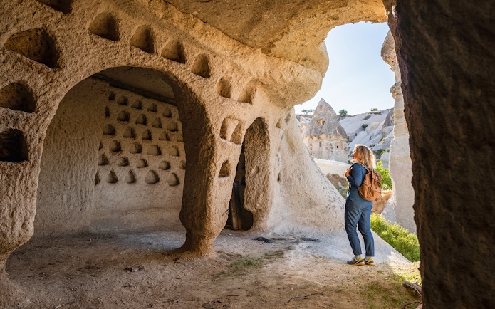 Guest exploring ancient cave dwellings at Goreme Open Air Museum, Cappadocia.
