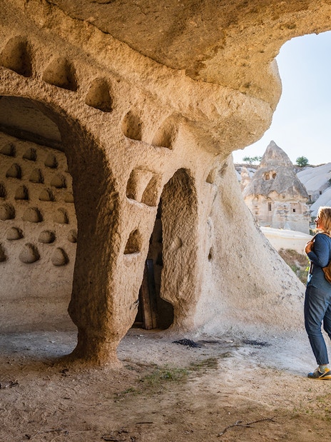 Guest exploring ancient cave dwellings at Goreme Open Air Museum, Cappadocia.