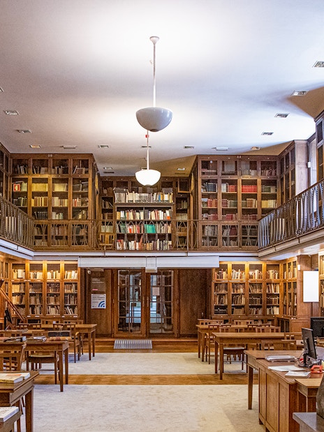 Library room with wooden bookshelves at the National Museum of Ancient Art.