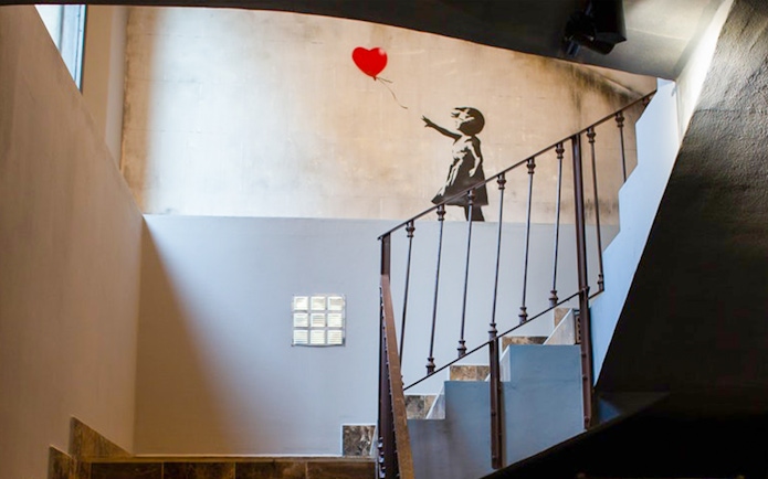 Banksy artwork of girl with balloon at Banksy Museum, Barcelona.