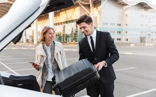 Private transfer service at London Stansted Airport with driver loading luggage.