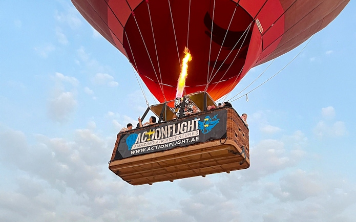 Hot air balloon with passengers in Ras Al Khaimah, UAE, during a morning ride.