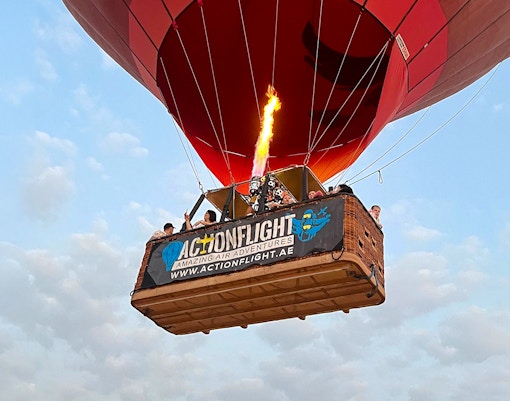 Hot air balloon with passengers in Ras Al Khaimah, UAE, during a morning ride.