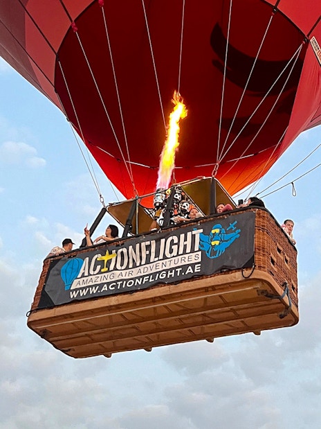 Hot air balloon with passengers in Ras Al Khaimah, UAE, during a morning ride.