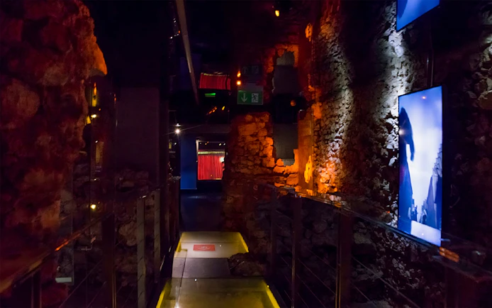 Rynek Underground Museum corridor with illuminated stone walls in Krakow.
