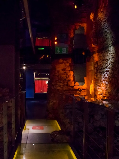 Rynek Underground Museum corridor with illuminated stone walls in Krakow.