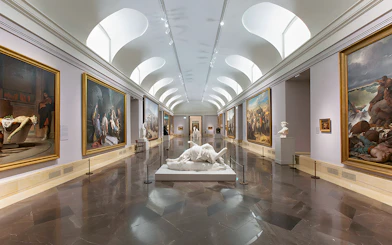 Prado Museum gallery with classical paintings and sculptures on display.