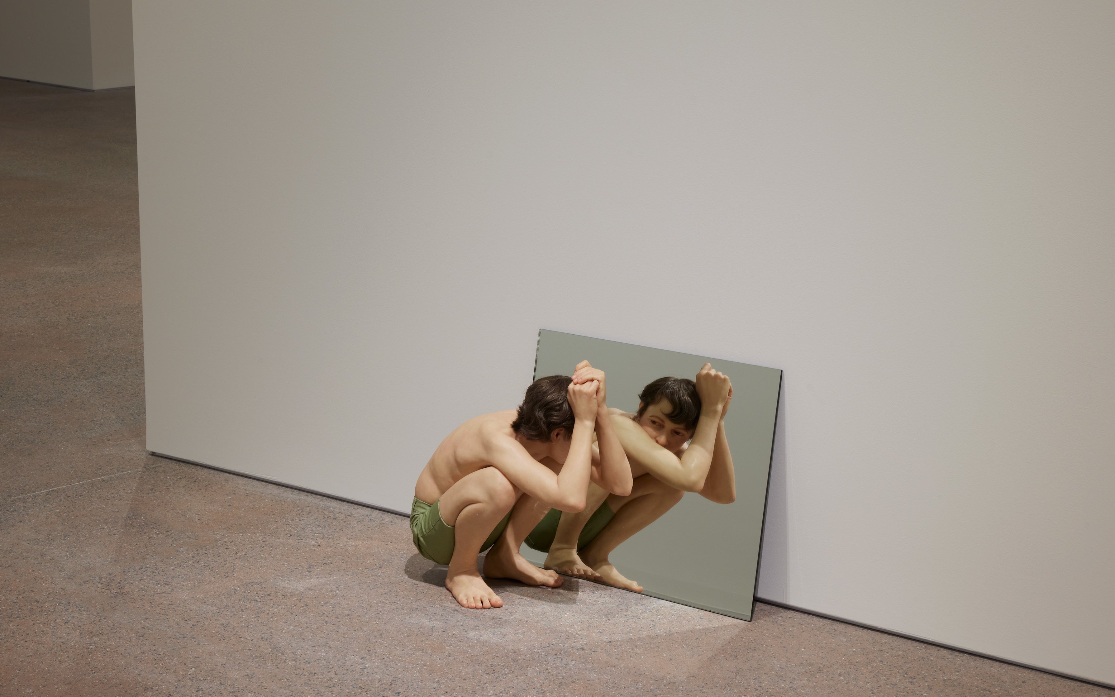 Hyperrealistic sculpture "Crouching Boy in Mirror" by Ron Mueck at Art Gallery of New South Wales, Sydney.