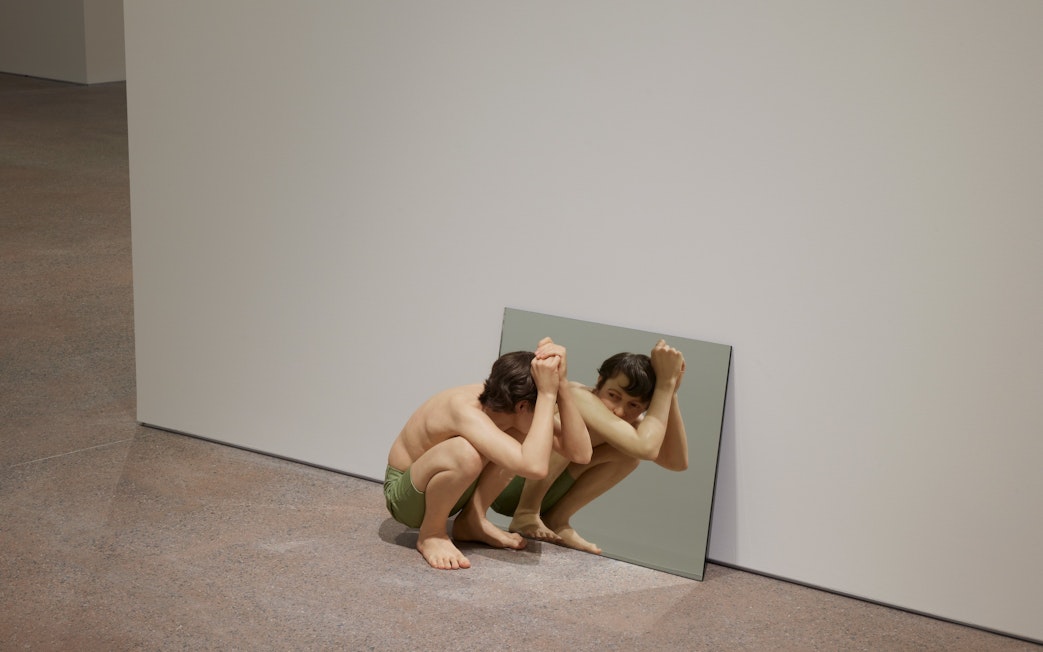 Hyperrealistic sculpture "Crouching Boy in Mirror" by Ron Mueck at Art Gallery of New South Wales, Sydney.