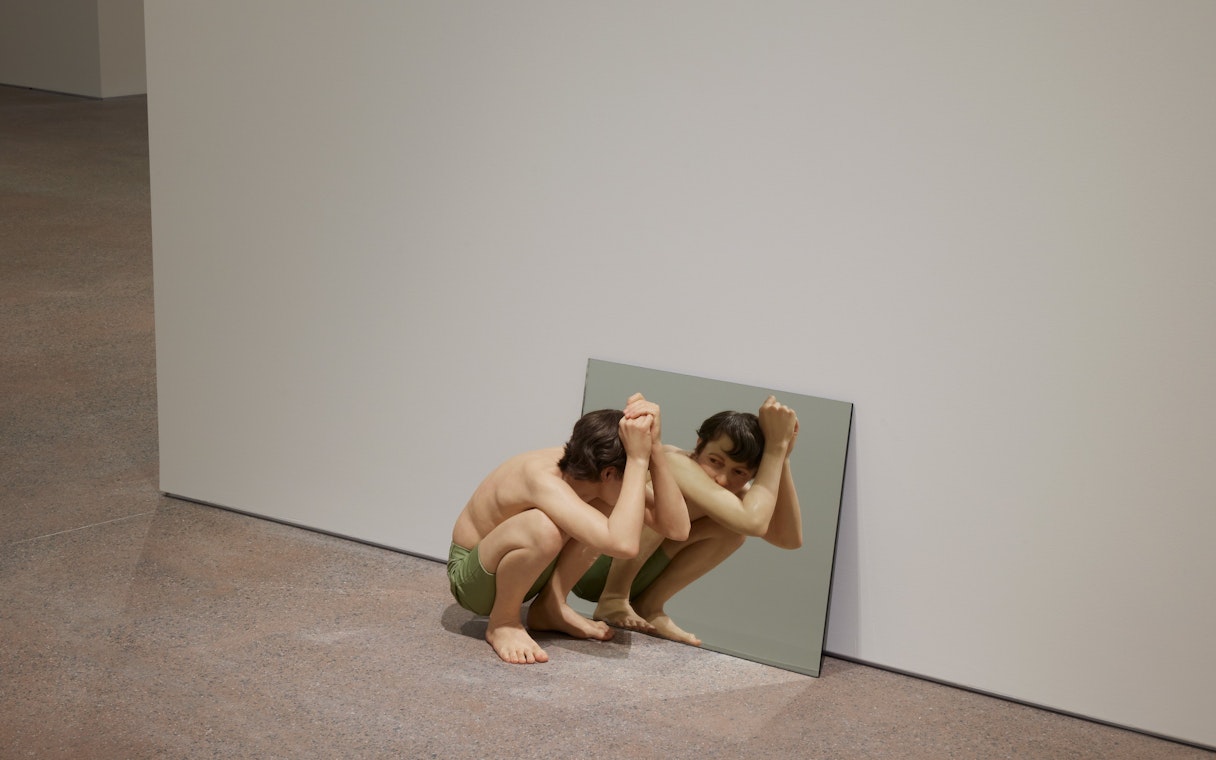 Hyperrealistic sculpture "Crouching Boy in Mirror" by Ron Mueck at Art Gallery of New South Wales, Sydney.