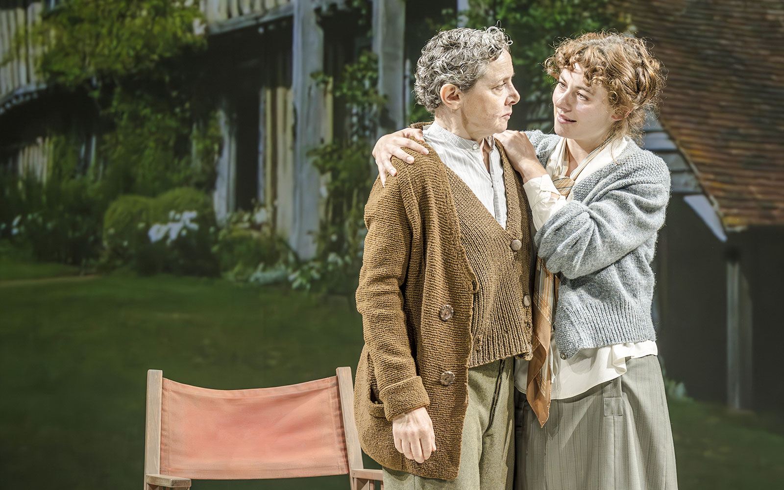 Performers in Grace Pervades West End show scene with garden backdrop.