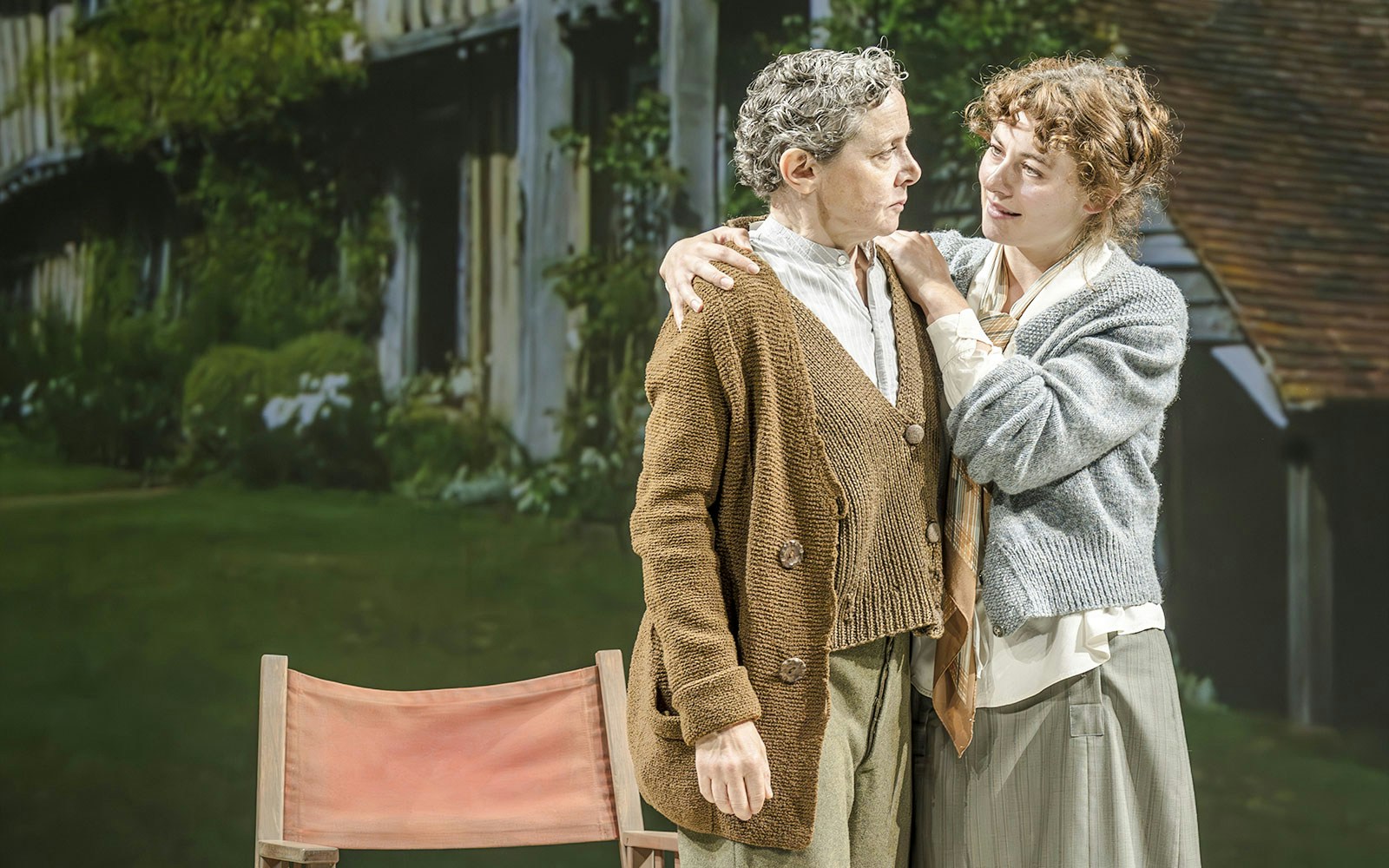 Performers in Grace Pervades West End show scene with garden backdrop.