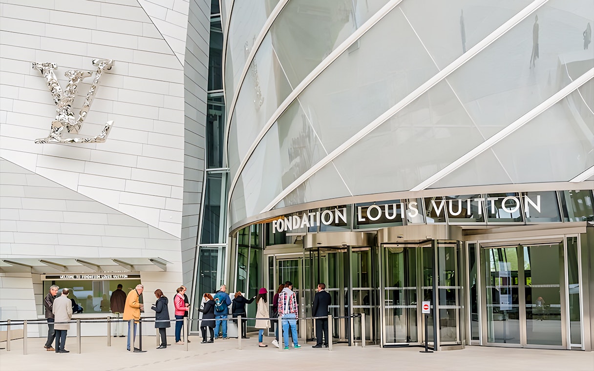 Visitors entering Fondation Louis Vuitton in Paris for VIP entry and history tour.