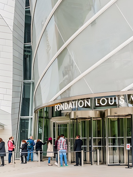 Visitors entering Fondation Louis Vuitton in Paris for VIP entry and history tour.