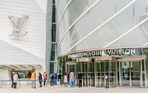 Visitors entering Fondation Louis Vuitton in Paris for VIP entry and history tour.
