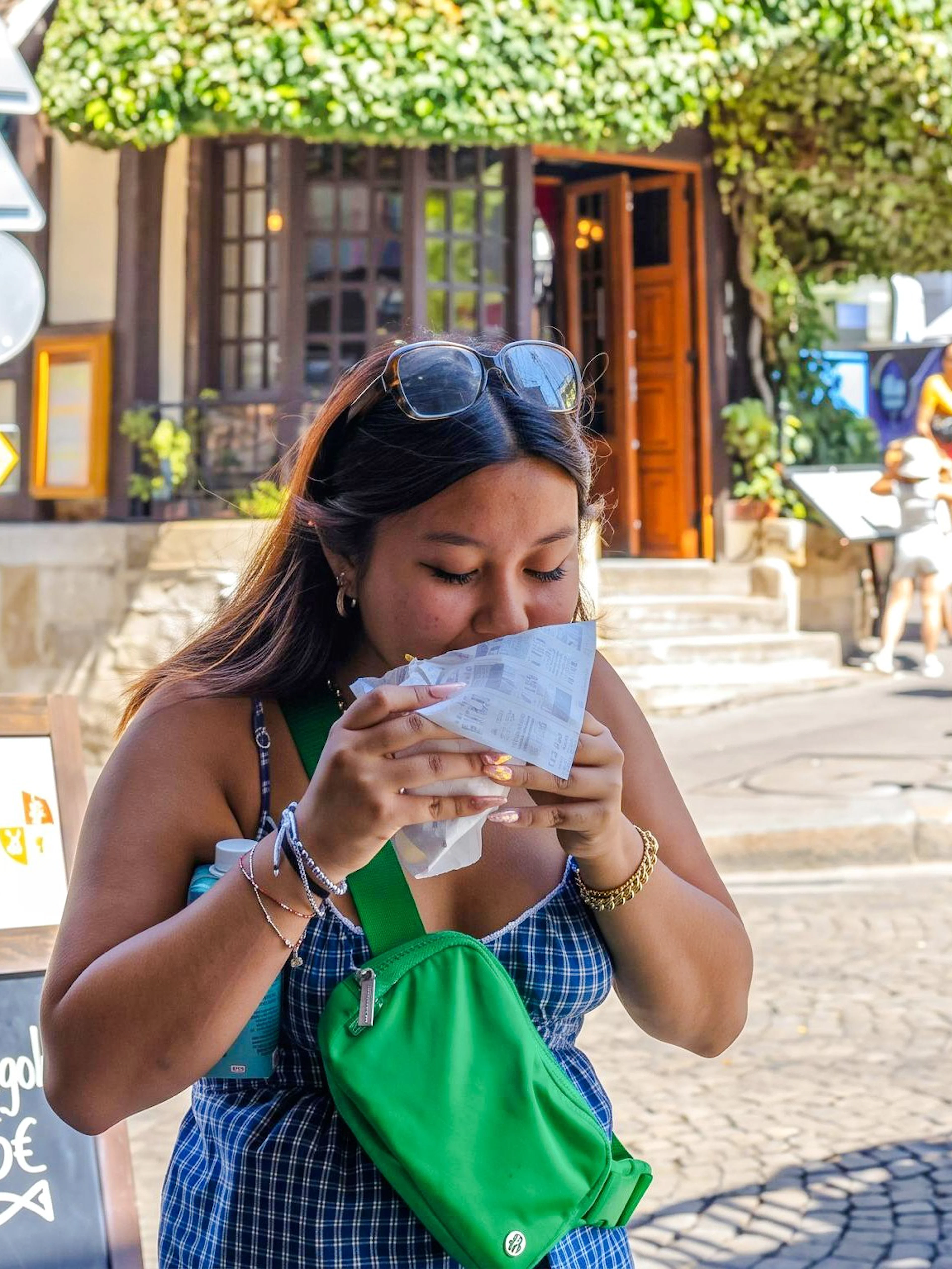 Person enjoying street food in Montmartre, Paris during a food tour.